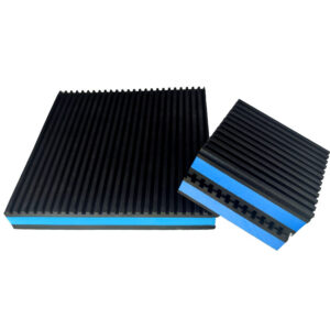 Blue EVA core anti vibration pad standing on edge beside a larger pad, showing the closed cell foam core between two ribbed rubber layers Title: Blue EVA anti vibration pad edge profile