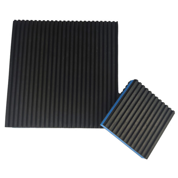Straight ribbed rubber surface of a blue EVA core anti vibration pad shown next to a tilted smaller pad