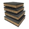 cork-rubber-anti-vibration-pad-stacked-four Four cork rubber anti vibration pads stacked at an angle, showing the granulated cork core between two ribbed rubber layers