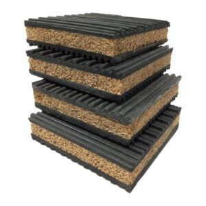 Four cork rubber anti vibration pads stacked at an angle, showing the granulated cork core between two ribbed rubber layers