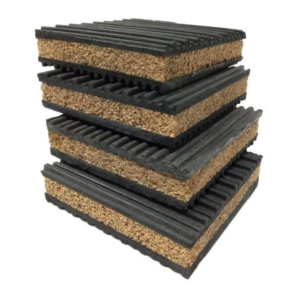cork-rubber-anti-vibration-pad-stacked-four Four cork rubber anti vibration pads stacked at an angle, showing the granulated cork core between two ribbed rubber layers