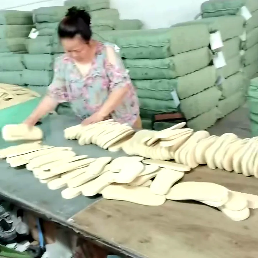 Worker sorting and inspecting die-cut EVA slipper soles
