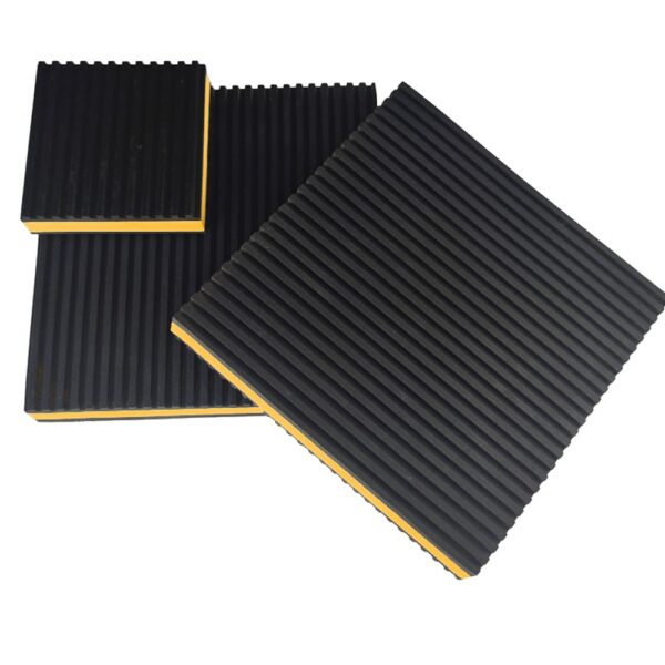Three yellow EVA core anti vibration pads in different square sizes arranged at an angle on a white background