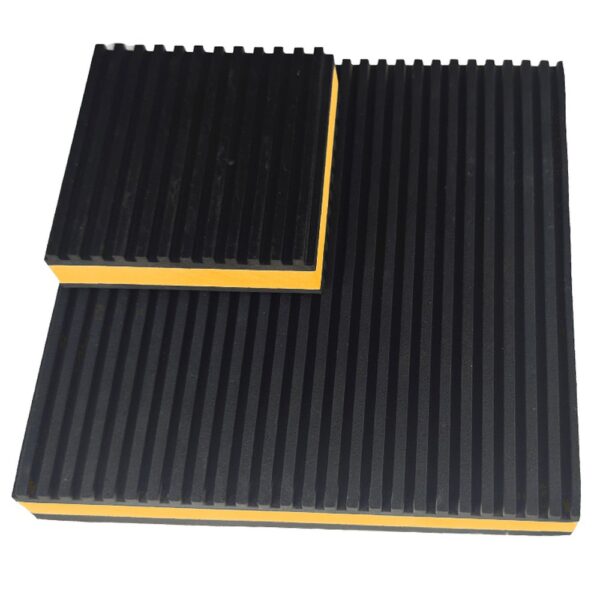 Smaller yellow EVA anti vibration pad resting on a larger pad, both with straight ribbed rubber facings