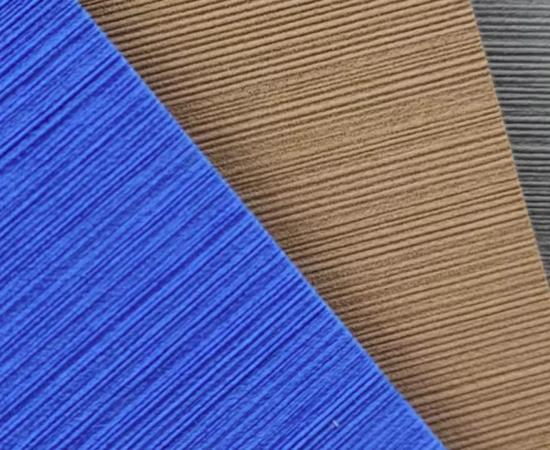 Close-up of brushed marine EVA foam sheet in blue, brown and grey, showing fine parallel brushed lines