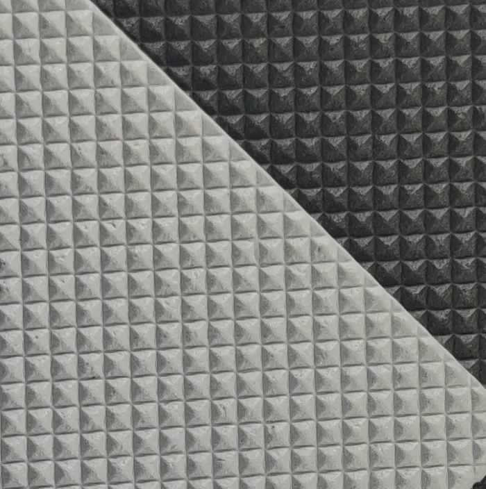 Close-up of embossed marine EVA foam sheet in light grey and black with a raised pyramid pattern