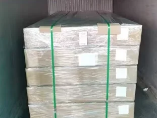 Cartons of marine EVA foam sheet on a pallet, strapped and loaded in a shipping container