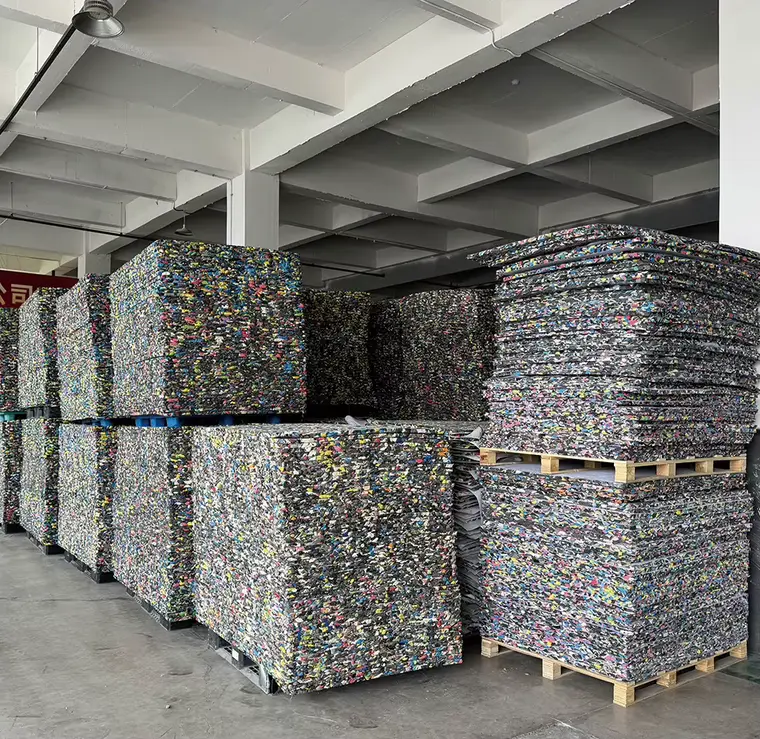 Rebonded EVA shock pad sheets stacked on wooden and plastic pallets, ready to ship