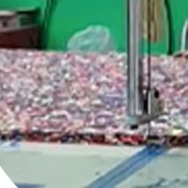 Band knife slicing a rebonded EVA foam block into turf shock pad sheets